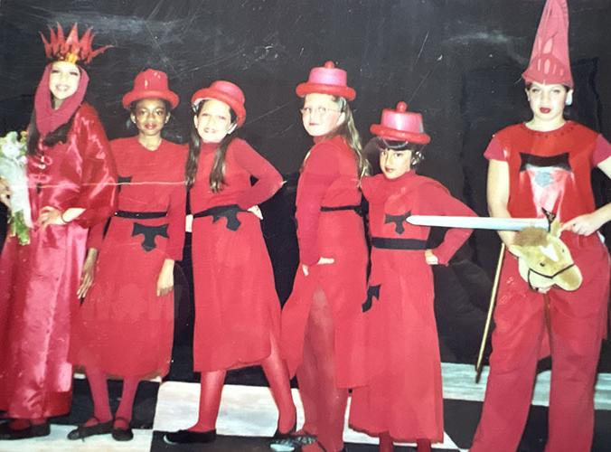 Girls in red costumes putting on a show